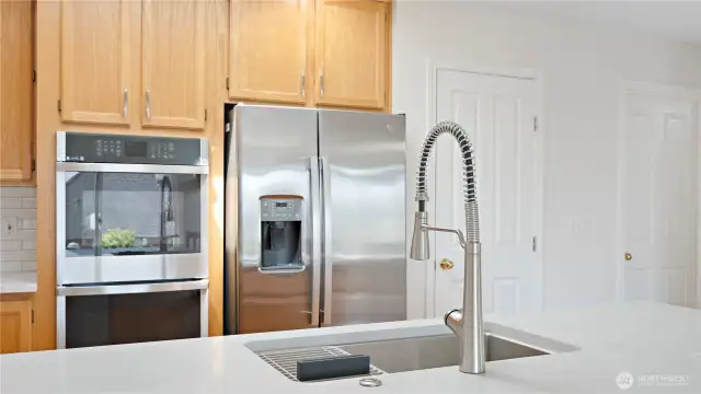 A nice big kitchen for you with a new sink and facet too.  First door on the right is the walk-in pantry.  Second door on the right goes into the utility room, then the big double car garage.