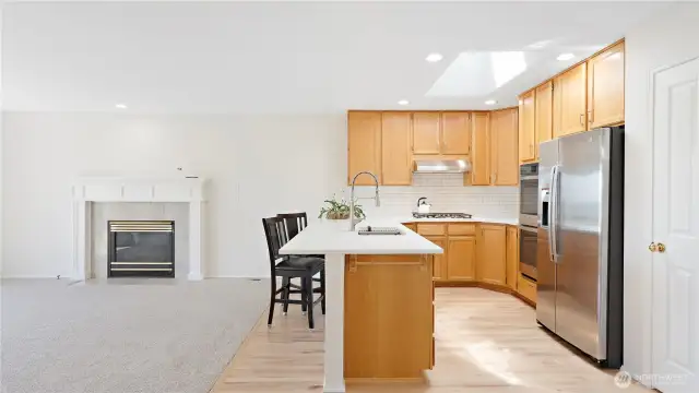 Kitchen opens up and flows into the family room on the left. The water views can be seen through the glass slider in the family room.