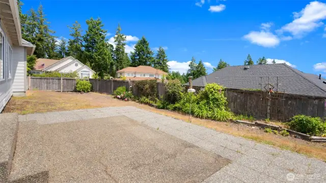 If we go out of the glass slider into the back yard; this is looking north.  The water view of Dyes Inlet is to the right.
