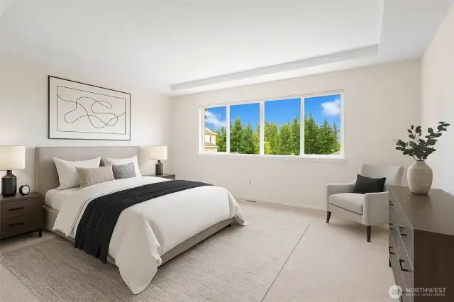 Back inside to the bedrooms.  This big primary bedroom has a coved ceiling and great views out to the east. You will enjoy the wonderful early morning sunshine coming in your window.