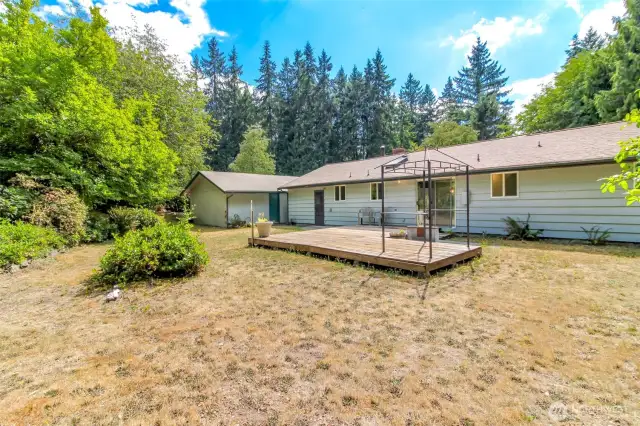 This view of the back of the home also shows the shed connected to the back of the detached garage.
