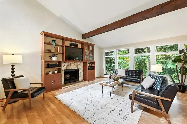 The living room with soaring ceilings, cedar beams and a wall of windows will wow you from the moment you walk in!