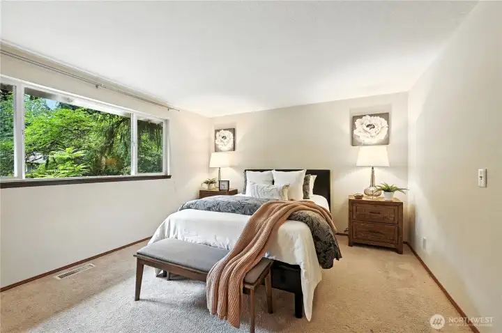 Primary bedroom with large windows.