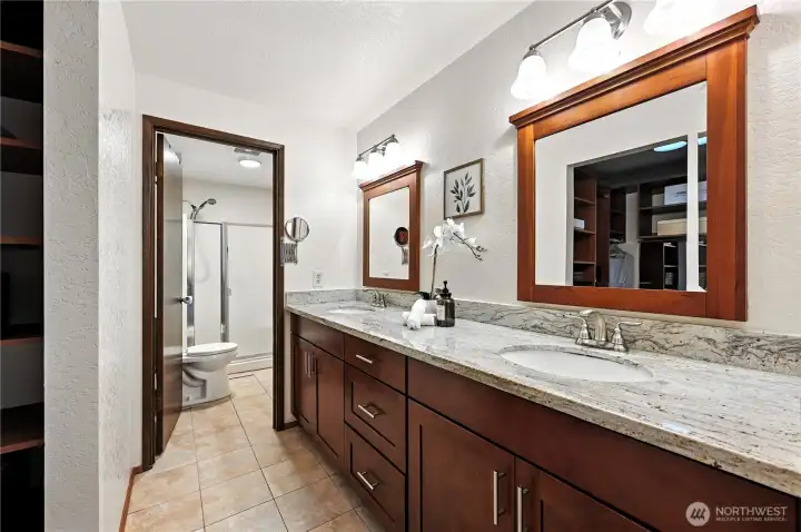 Primary bath has two sinks and a generous countertop.
