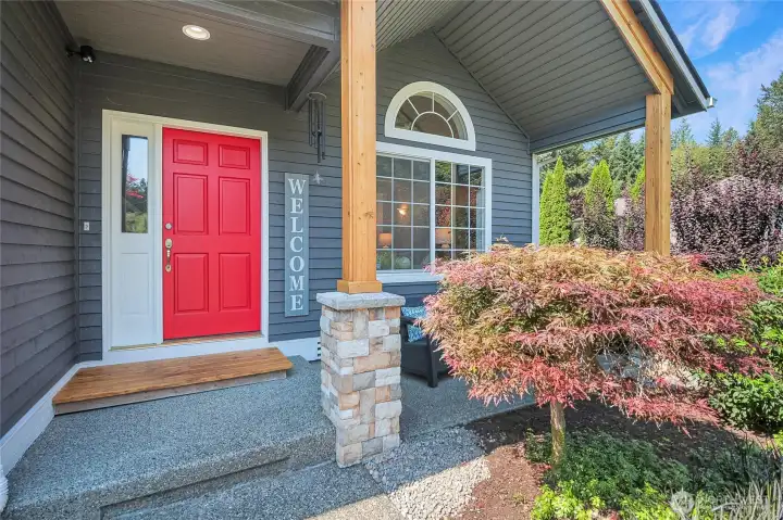 The charming front porch welcomes you to the home. Cedar pillars encased in stone add to the craftsman feeling.