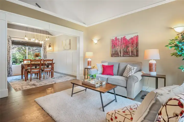 The living room and dining room offer a vaulted ceiling with high-end molding details.