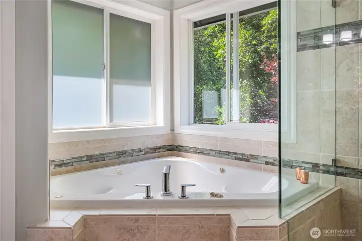The jetted tub offers views to the private rear yard.