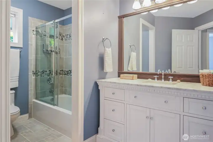 The full bath with upgraded vanity and marble counter, is conveniently located in the hall near the bedrooms.