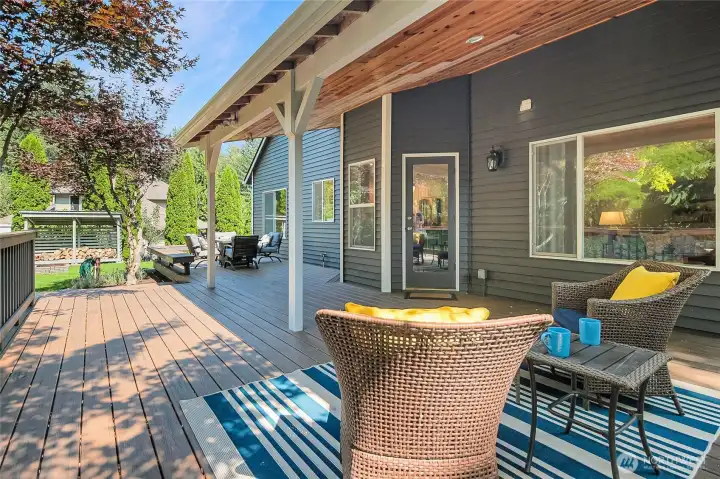 A view of the rear of the home and the low maintanence deck with built-in bench seating.