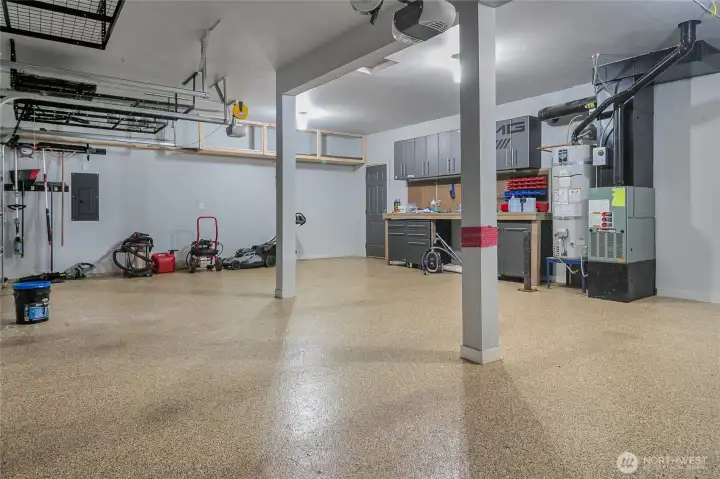 The garage offers 2 door openers, epoxy coated flooring, built-in cabinets and work bench area and plenty of overhead storage. A door leads to the rear yard.