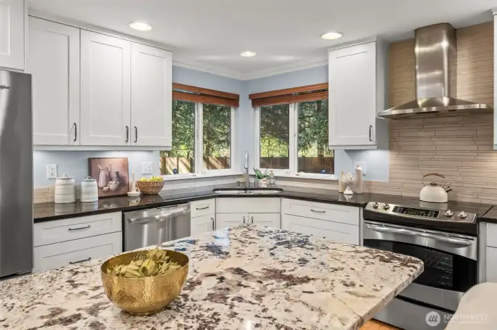 Updated kitchen with granite counters and stainless steel appliances.