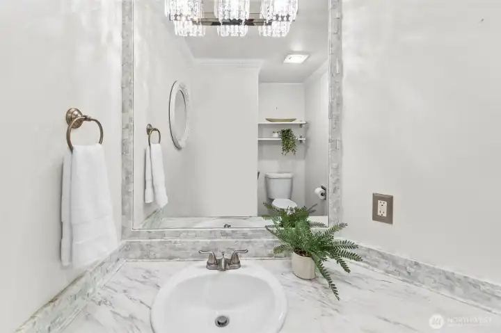 Powder bathroom on the main floor with graceful lighting details.