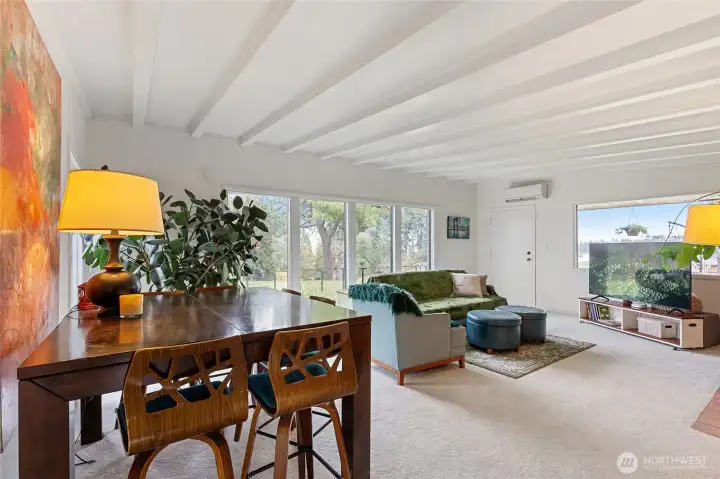 Spacious warm inviting open living and dining area with fireplace.