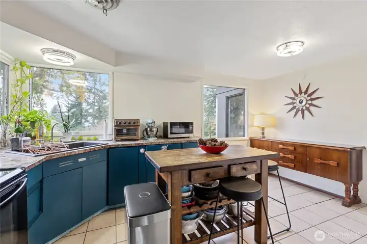 open, eat-in kitchen with large picture windows