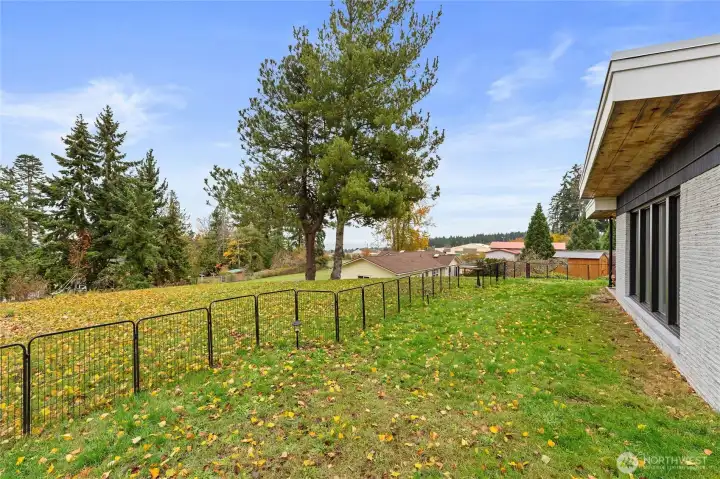 Spacious exterior spaces with room to garden, play and take in view. Property extends beyond the fence.