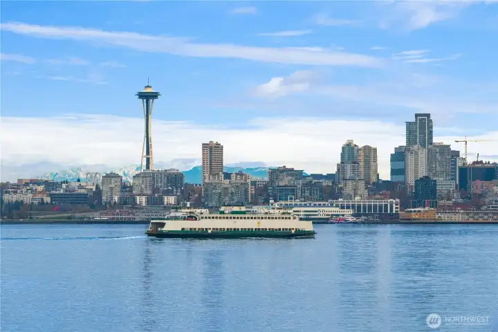 The Seattle skyline is backed by the Cascade mountains and fronted by the always moving marine traffic of Elliott Bay.