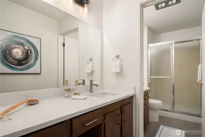 Part of the primary suite are these dual sinks with new quartz counters and fixtures as well as new LVP flooring.