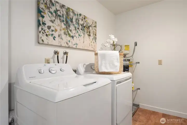 The full size and separate laundry room has cork flooring and a newer water heater as well as extra storage areas.
