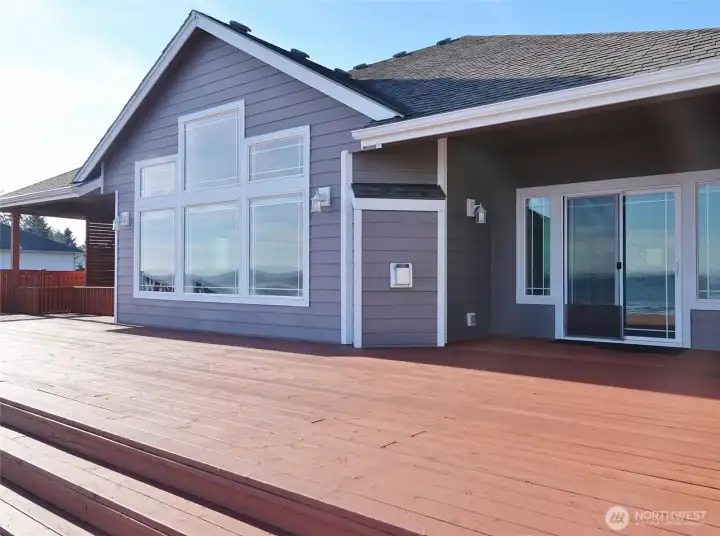 Rear view of the home with huge Deck. Slider off the Guest Bedroom on the north-side of the home.