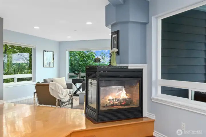 Gas fireplace connects living and dining rooms