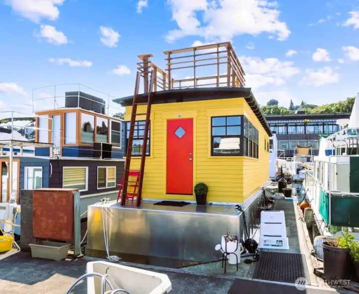 Houseboat entrance with new roof deck, solid cedar siding