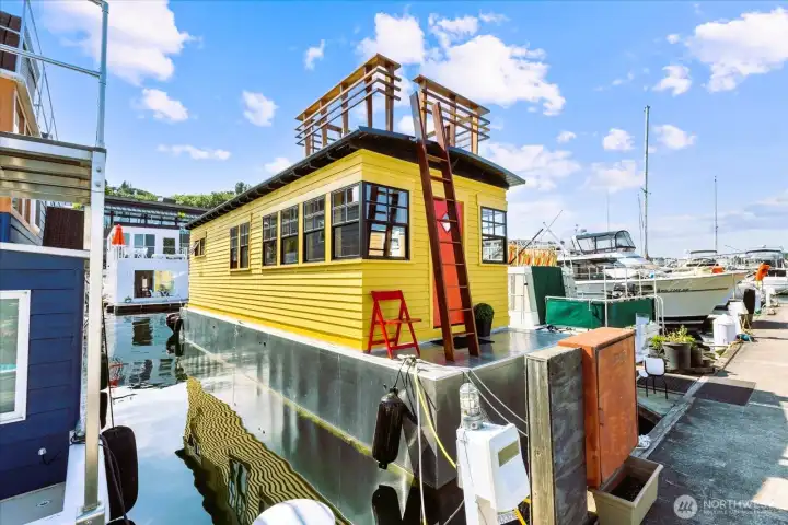 Houseboat entrance showing new aluminum hull and roof deck.