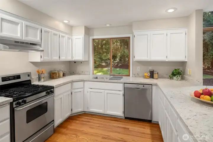 Your kitchen boast new Quartz counters, stainless appliances, tons of storage, seating, and a tranquil forested outlook.