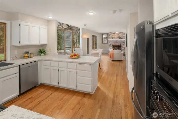Your kitchen boast new Quartz counters, stainless appliances, tons of storage, seating, and a tranquil forested outlook.