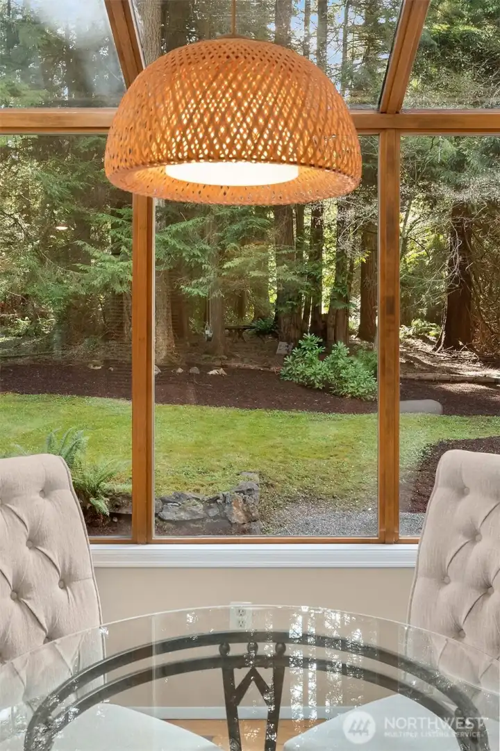 Your kitchen boast new Quartz counters, stainless appliances, tons of storage, seating, and a tranquil forested outlook.