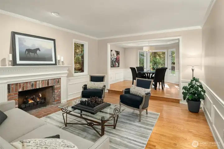 The living room continues the design style throughout the main floor featuring wainscotting, crown molding and attractive trim details.
