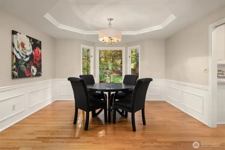 The dining room features a coved ceiling and views to the back yard.