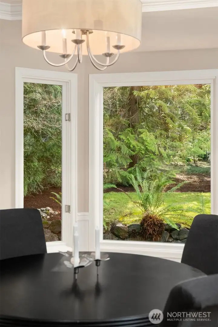 The dining room features a coved ceiling and views to the back yard.