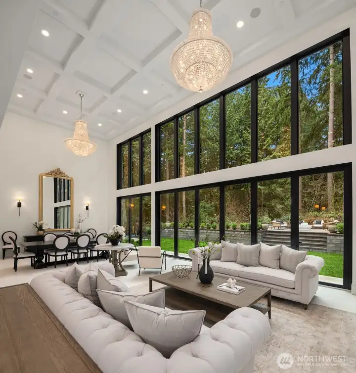 Great room with coffered ceilings and two elegant chandeliers