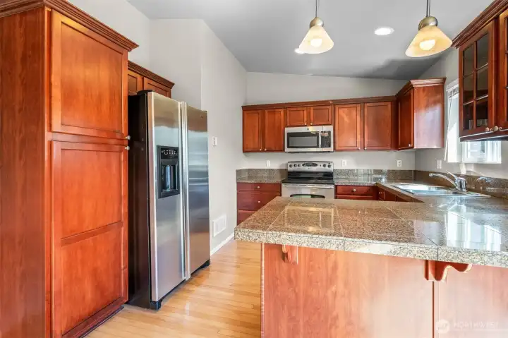 Positioned right off the main living area, the kitchen keeps you connected while you cook