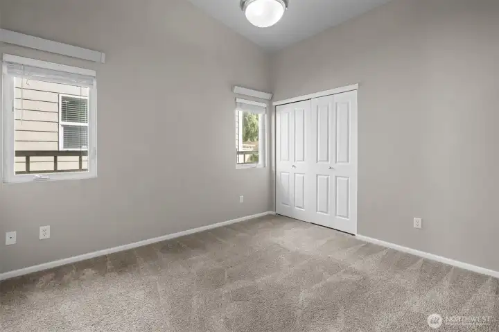A functional bedroom with closet space and natural light