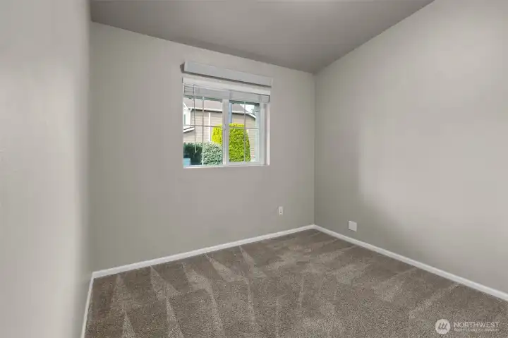 A light-filled secondary bedroom with a comfortable, easy layout