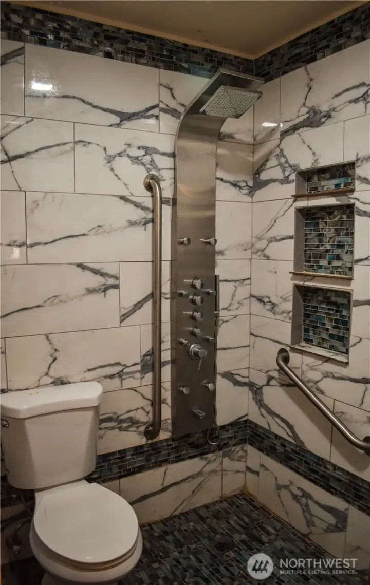 Shower room with 400 lb flip down shower chair.  Plumbing has been all redone.