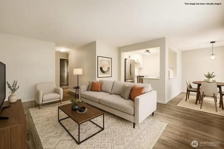 Living room with kitchen and dining area in the background