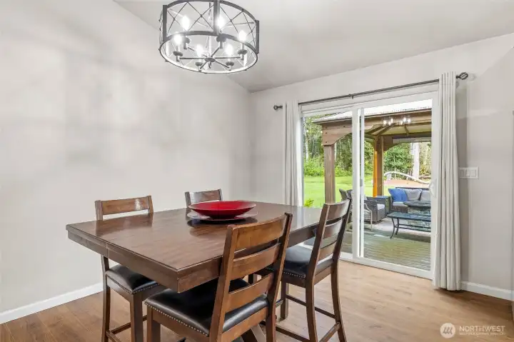 Spacious dining space with sliding glass door to back deck, gazebo and bbq space.