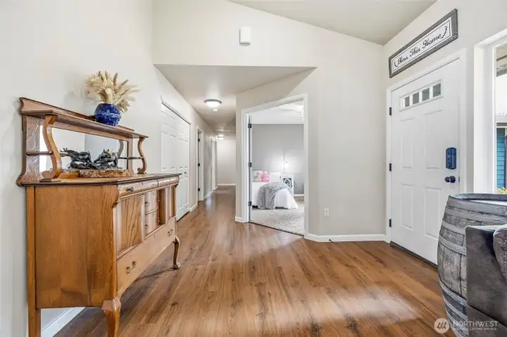 View down hall from entry.  Large closet on left.  French doors lead to office.