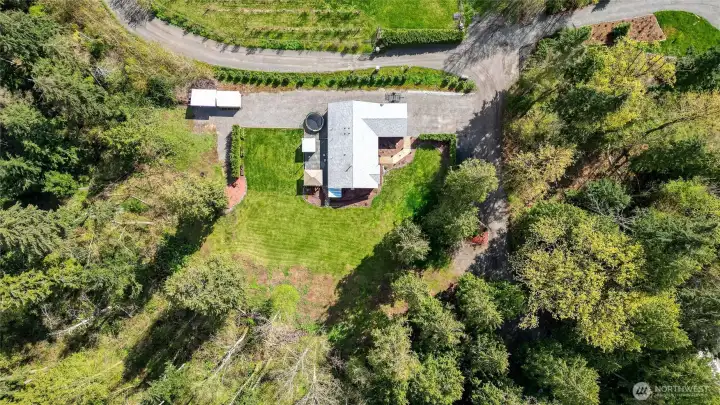 Aerial view of building site.  Second spot you could build an outbuilding just as you approach home on right before line hedge lining drive.