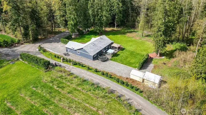 Aerial looking to the West of property back to private drive.