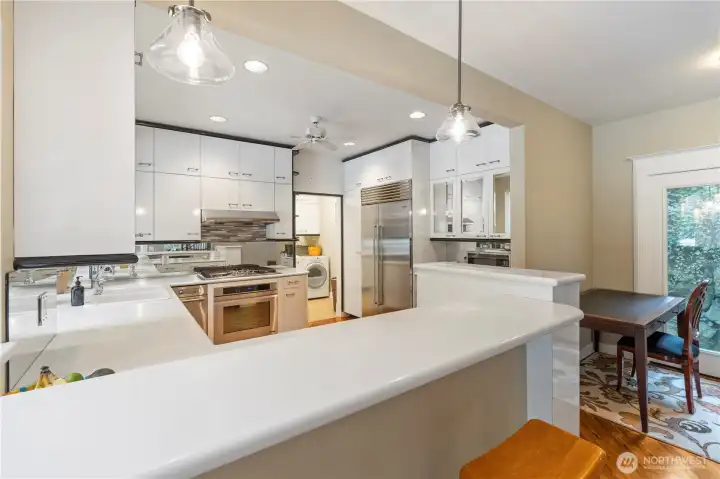 Form & function meet in this big kitchen with lots of cabinets, stainless steel appliances & wonderful counter space. The space to the right can be a work space or an eating nook plus there's a breakfast bar.
