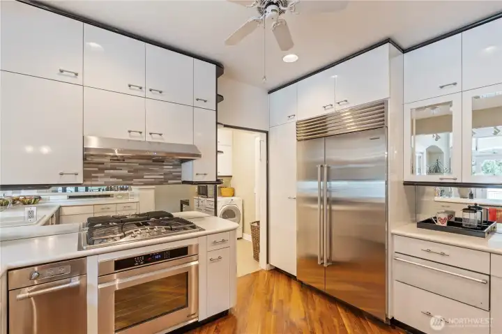 Newer Sub Zero fridge, Thermodor warming drawer, Dacor oven, trash compactor, 5 burner gas stovetop, big pantry with rollout shelves, so much storage in this kitchen-this is a chef's delight!