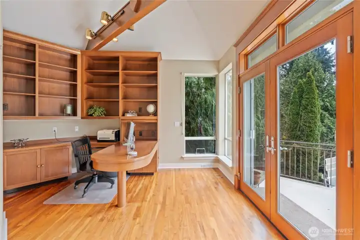 Beautiful office with French doors leading to the patio, built-in desk, cabinets & shelving that were beautifully & tastefully done, hardwood floors, lots of natural light... a place that makes you want to go to work!
