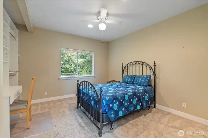 Spacious secondary bedroom with built-in shelving & desk