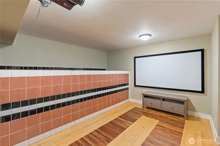 Projector & screen stay with the house. Beautiful hardwood floors & tile work.