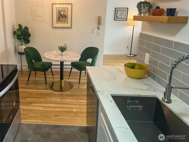 The kitchen also features a large stainless sink and modern faucet. The dining room is perfectly placed adjacent to the kitchen and living rooms.