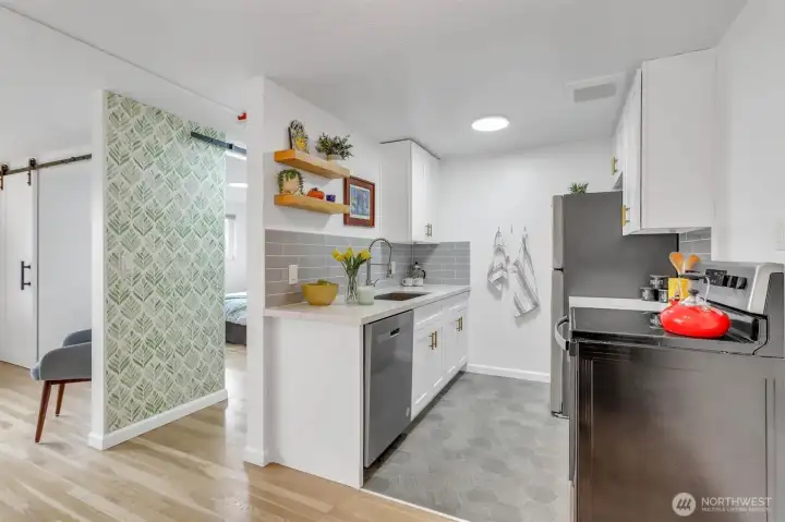 This view from the dining room features super-stylish wallpaper on a feature wall.