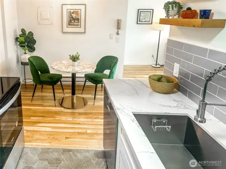 The kitchen also features a large stainless sink and modern faucet. The dining room is perfectly placed adjacent to the kitchen and living rooms.